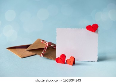 Valentine's Day Love Letter Mockup. Craft Envelope With White Blank Card And Hearts On Blue Background. Valentines Day, Mothers Day, Womens Day Greeting Card.