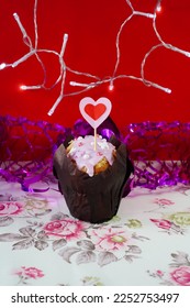 Valentine's Day muffin with heart shaped flag and garland on red background, template with copy space.  - Shutterstock ID 2252753497