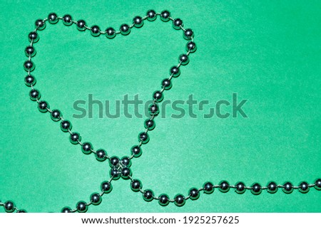 Valentine's Day. On a light background, a heart made of yellow beads.