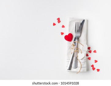 Valentines Day (or Wedding) Meal Background With Hearts, Fork, Knife, White Napkin. Romantic Holiday Table Setting. Beautiful Background With Blank. Restaurant Concept. Flat Lay