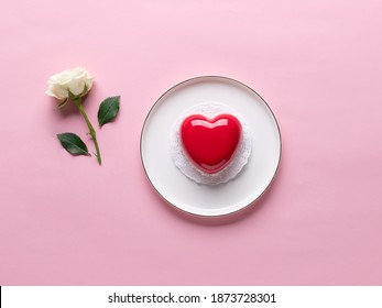 Valentines day pink background. red heart cake and white rose. flat lay. place for your text or design
