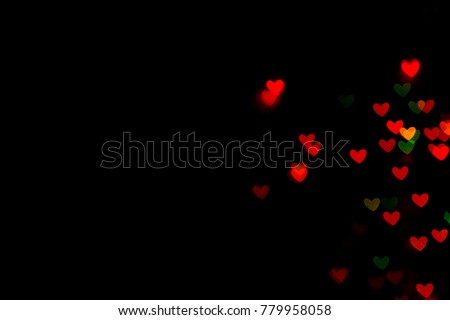 Valentine's day red bokeh hearts on black background   
