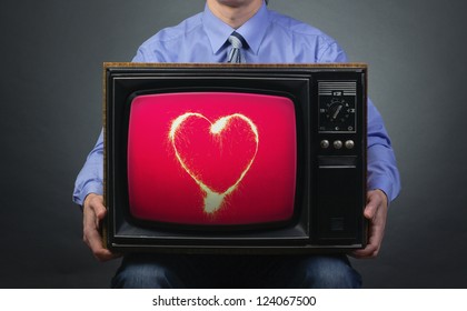 Valentine's Day. Retro TV Featuring Sparkling Heart In The Hands Of Men.