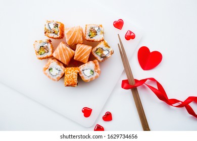
Valentine's Day. Sushi and sticks on a white background.
The concept of a romantic dinner at a sushi bar. The portfolio has more images by February 14th.
