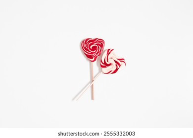 Valentine's Day, sweet background. Two heart-shaped lollipops on white background. Top view, flat lay, minimal background for Valentine's Day. Valentine's Day card. banner - Powered by Shutterstock