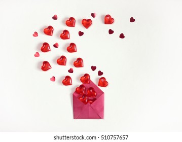 Valentine's Day, White Background, Red Envelope With A Heap Of Transparent Hearts And Confetti