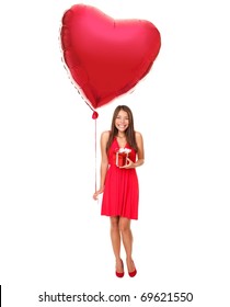 Valentines Day Woman Holding Gift And Red Heart Balloon. Cute Beautiful Young Woman Smiling In Red Dress. Asian / Caucasian Female Model Isolated On White Background In Full Length.