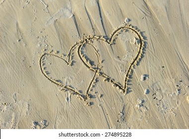Valentines Drawn on Sandy Beach