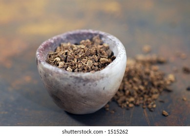 Valerian root, a calming herb and sleep aid, in a natural dish.