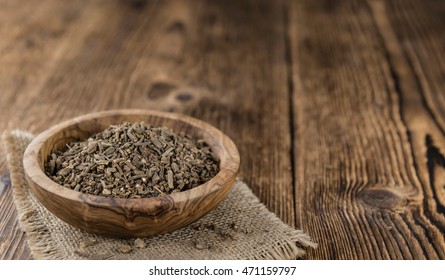 Valerian roots (dried; detailed close-up shot) on wooden background