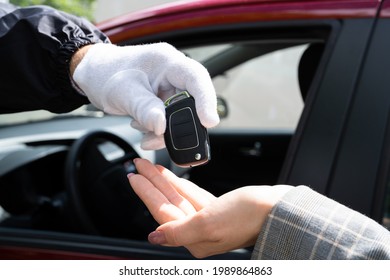 Valet Parking Giving Car Key To Young Woman