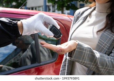 Valet Parking Giving Car Key To Young Woman