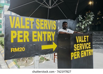  A valet service worker waits his customer  in front of the restaurant in Kuala Lumpur, Malaysia on November 25, 2017