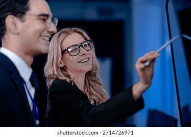 Validating the future AI. A specialist points out a crucial parameter in an AI model's code displayed on screen discussing its ethical implications with her colleague before deployment.