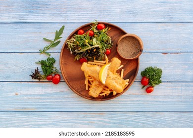 Valle Black Pepper Cod Fish And Chips With Salad, Lime And Cherry Tomato Served In Dish Isolated On Wooden Table Top View Fastfood