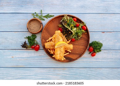 Valle Black Pepper Cod Fish And Chips With Salad, Lime And Cherry Tomato Served In Dish Isolated On Wooden Table Top View Fastfood