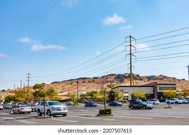 Vallejo, California - July 23 2022: Overhead Power Cables Held By Pylons Alongside A Parking Lot At A Strip Mall In Vallejo, California