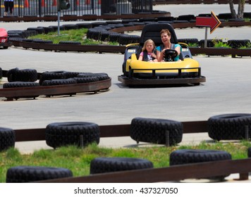 VALLEJO, CALIFORNIA, USA - JUNE 14, 2016:  Six Flags Theme Park,  Mom And Doughter Driving Thunder Road Speedway Go-Karts Racing Track
