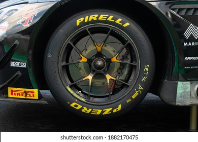 Vallelunga, Italy 5 december 2020, Aci racing weekend. Pirelli racing tire on touring car wheel close up on track yellow name logo brand side view
