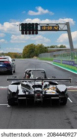 Vallelunga, Italy, November 28 2021, Race Weekend. Rear View Of Racing Car Standing On Starting Grid, Straight Asphalt Racetrack And Starting Lights