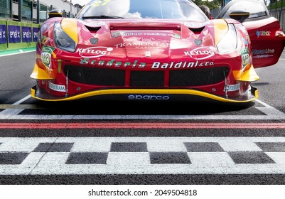 Vallelunga, Italy September 19th 2021 Aci Racing Weekend. Red Ferrari 488 GT Low Angle View Close Up On Asphalt Circuit Checkered Line