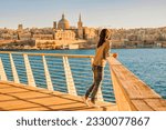 Valletta Malta city Skyline, colorful house balcony Malta Valletta city, young Asian woman visit Malta during a vacation