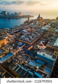 Valletta  Malta    Sunrise above Valletta and Our Lady Mount Carmel church   St Paul's Cathedral and Sliema at background