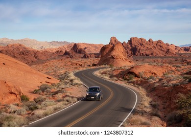 Valley Of Fire State Park, Nevada, United States - November 14, 2018: Car Driving On A Scenic Road In The Desert During A Cloudy And Sunny Day.