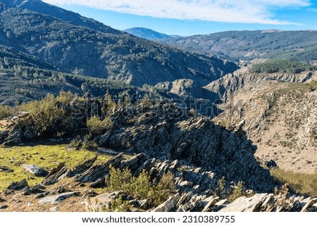 Valley formed by rocky mountains of capricious shapes in the Sierra del Rincon, Madrid.