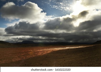 Valley and hills under a gloomy sky with thunderclouds. Dramatic view of the breadth of space. Iceland.