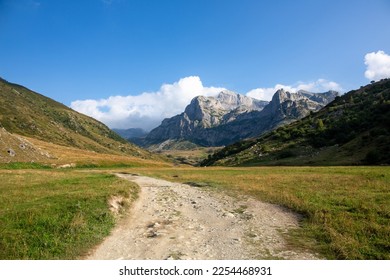 A valley in the mountains of the Alps in Italy in summer, with a dirt road. A quiet and peaceful place in the mountains for easy hikes - Shutterstock ID 2254468931