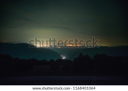 Valley in the mountains at night with the lights