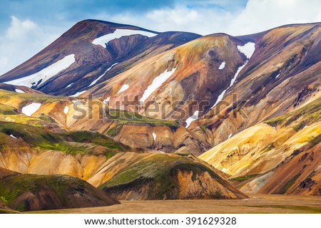 Valley National Park Landmannalaugar. On the gentle slopes of the mountains are snow fields and glaciers. Magnificent Iceland in the July