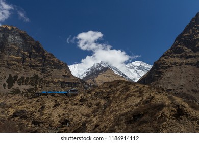 Valley On Annapurna Base Camp (Annapurna Sanctuary) Trek In Himalayas, Nepal. View Of Rocky Trail And Distant Snowy Peaks. Distant View Of Machapuchre Base Camp