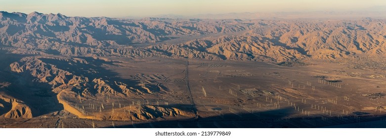 The valley of Palm Springs landscape in fall on a hazy, warm afternoon from aerial, above shot. 
