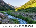 Valley with Snowmass creek snowmelt blue color water on Snowmass Lake hike trail in Colorado in National Forest park