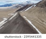 The Valley of Ten Thousand Smokes in Katmai National Park and Preserve in Alaska is filled with ash flow from Novarupta eruption in 1912. Aerial view of ash filled valley between mountains.