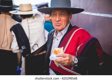 VALPARAISO, QUINTA REGION / CHILE - MAY 21 2016 - Unidentified chilean huaso eating empanadas at the street