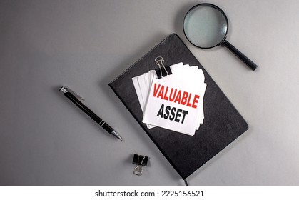 VALUABLE ASSET Text On Sticky On Black Notebook , Business Concept