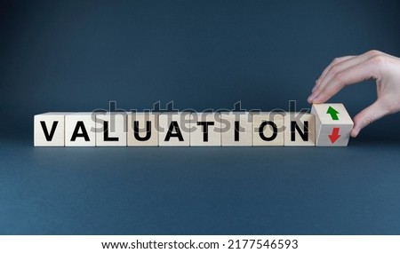 Valuation up or down. The cubes form the words Valuation up or down arrows. Valuation concept