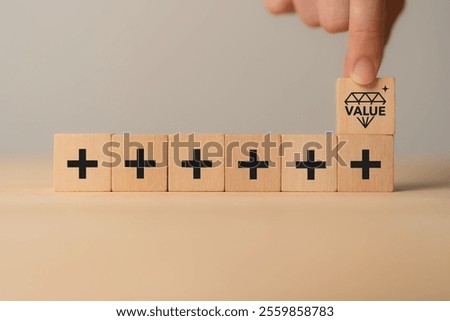 Value added concept. Way to adding value to product and service. Wooden blocks with value added icons. Improving products, excellent service, expert advice, consistently upgrade, deliver fast.