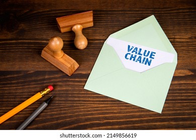 Value Chain. Letter And Office Supplies On A Wooden Background.