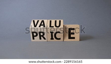 Value and Price symbol. Wooden cubes with words Price and Value. Beautiful grey background. Business and Value and Price concept. Copy space