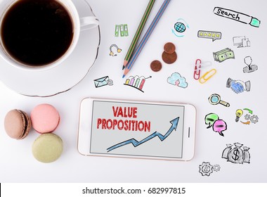 Value Proposition, Business Concept. Mobile Phone And Coffee Cup On A White Office Desk