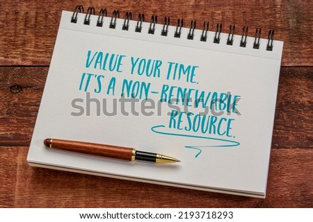value your time, it's a non-renewable resource, writing in a spiral notebook against rustic wood, productivity and personal development concept
