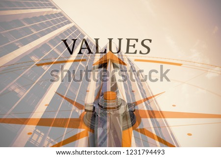 Values against compass against low angle view of office building against blue sky
