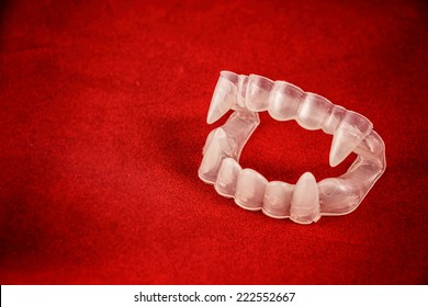 Vampire Costume Fangs On Red. Classic Halloween Costume Vampire Teeth With Fangs On Red.