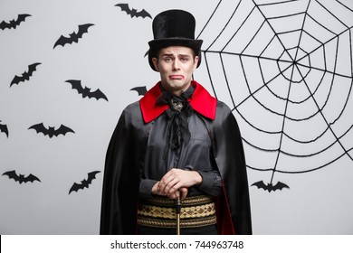 Vampire Halloween Concept - Portrait Of Handsome Caucasian In Vampire Halloween Costume With Sad Facial Expression. 