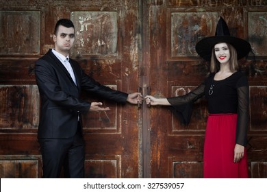 Vampire And Witch Opening The Door Of The Haunted House And Welcoming You To The Monster's Ball