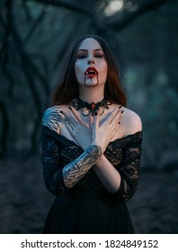  vampire woman with sharp fangs, drops of blood on red lips. Close-up portrait of beautiful lady. Festive art make-up. Gothic lace choker on the neck. Medieval sexy girl 